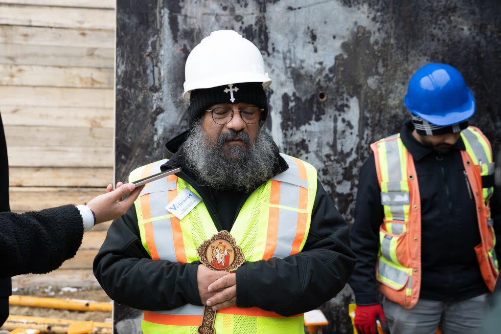 His Grace Bishop Boulos holding an icon and cross at the blessing of the community centre foundation