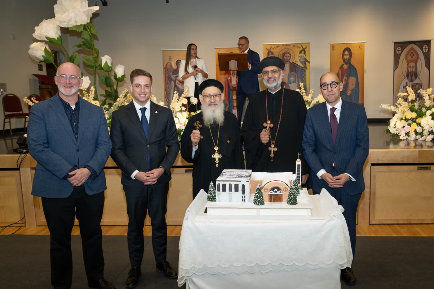 Guests and clergy with the celebration cake